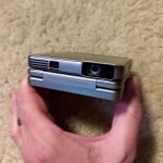 Aurzen ZIP Tri-Fold DLP Truly Mini Projector. Pocket Size. Zero-Lag Focus. One-Click Screen Mirroring. Full-Screen Mode. Type-C Fast Charging. 5.000mAh Battery. Indoor Outdoor Portable Projector.Gold photo review